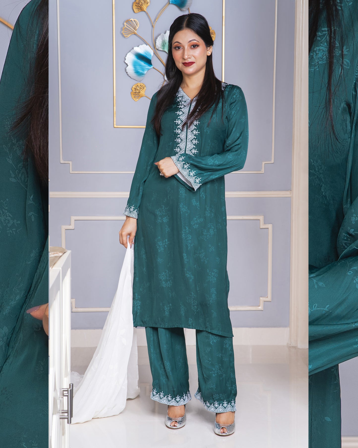Woman wearing a green kameez with intricate patterns in a decorated room.