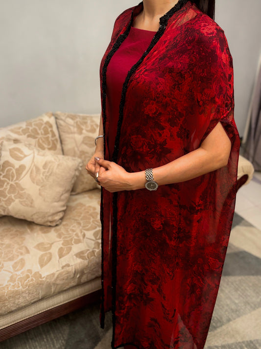 Bathed in the rich hue of a blossoming twilight, this Taraashi Platinum design drapes the wearer in an aura of captivating allure. The fluid silhouette, layered with a textured, almost ethereal fabric with intricate handwork (zardousi work), whispers of sophisticated grace. Delicate embellishments trace the edges, adding a touch of exquisite detail to the deep, resonant color. This is an attire for moments that demand attention, a seamless blend of tradition and contemporary finesse.