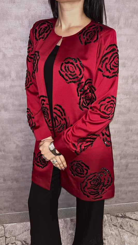 From Taraashi's exclusive Platinum Collection, the Satin Rose 3 Piece Set exudes undeniable glamour. A stunning red satin jacket showcases bold, dimensional black rose embellishments, a detail echoed subtly on the coordinating black trousers. Layered over a sleek inner top, this striking ensemble balances high-impact drama with sophisticated artistry. Command attention with the unforgettable style unique to our Platinum pieces.