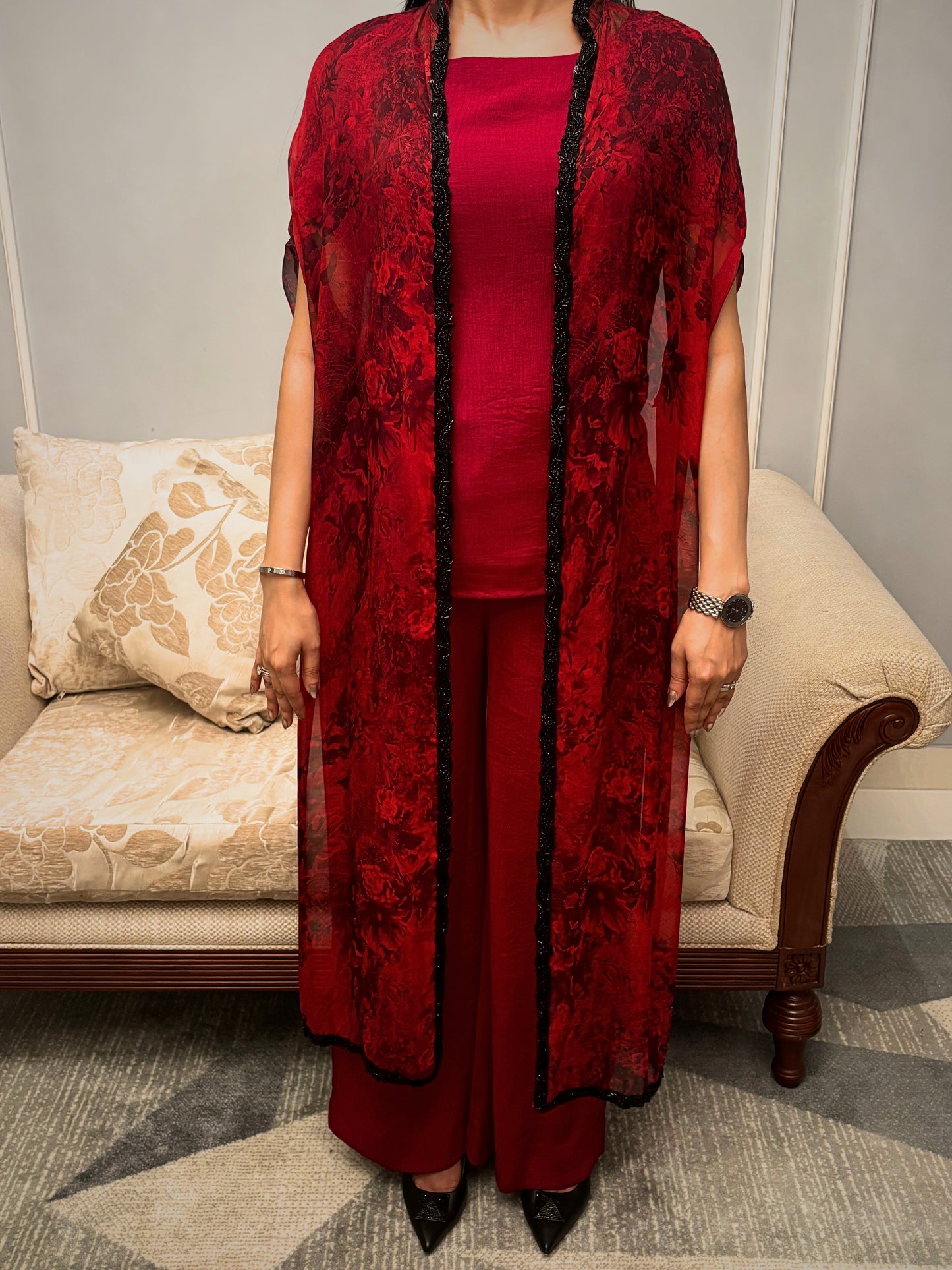 Bathed in the rich hue of a blossoming twilight, this Taraashi Platinum design drapes the wearer in an aura of captivating allure. The fluid silhouette, layered with a textured, almost ethereal fabric with intricate handwork (zardousi work), whispers of sophisticated grace. Delicate embellishments trace the edges, adding a touch of exquisite detail to the deep, resonant color. This is an attire for moments that demand attention, a seamless blend of tradition and contemporary finesse.