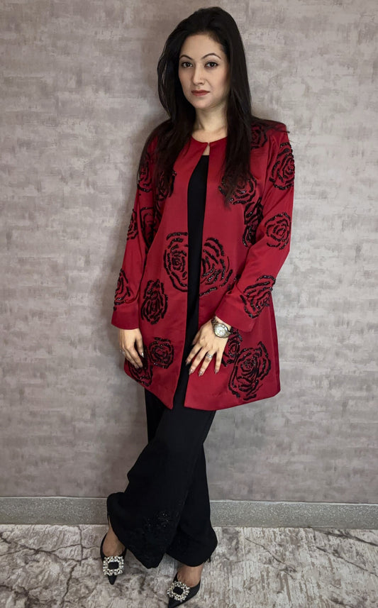 From Taraashi's exclusive Platinum Collection, the Satin Rose 3 Piece Set exudes undeniable glamour. A stunning red satin jacket showcases bold, dimensional black rose embellishments, a detail echoed subtly on the coordinating black trousers. Layered over a sleek inner top, this striking ensemble balances high-impact drama with sophisticated artistry. Command attention with the unforgettable style unique to our Platinum pieces.