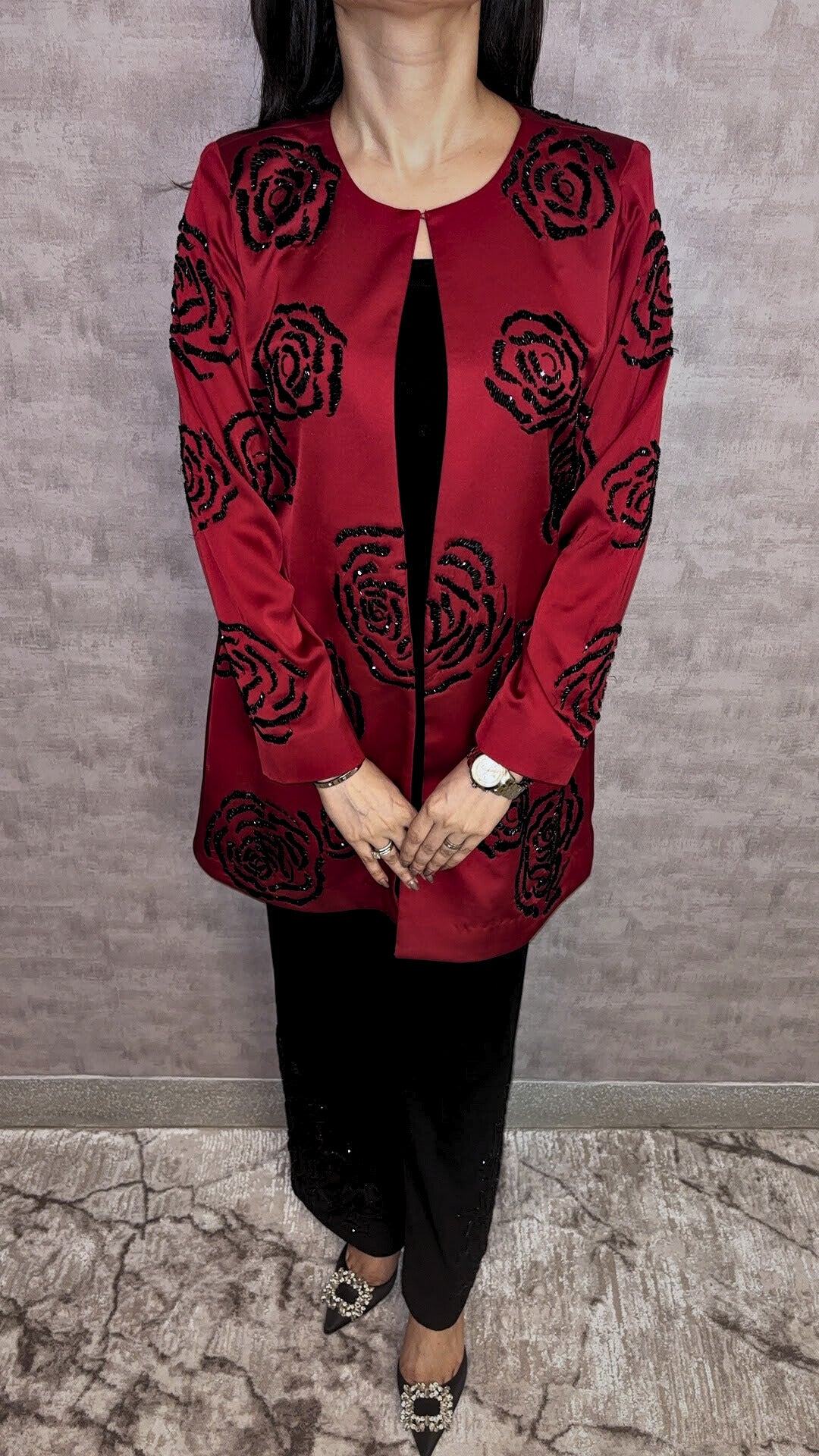 From Taraashi's exclusive Platinum Collection, the Satin Rose 3 Piece Set exudes undeniable glamour. A stunning red satin jacket showcases bold, dimensional black rose embellishments, a detail echoed subtly on the coordinating black trousers. Layered over a sleek inner top, this striking ensemble balances high-impact drama with sophisticated artistry. Command attention with the unforgettable style unique to our Platinum pieces.