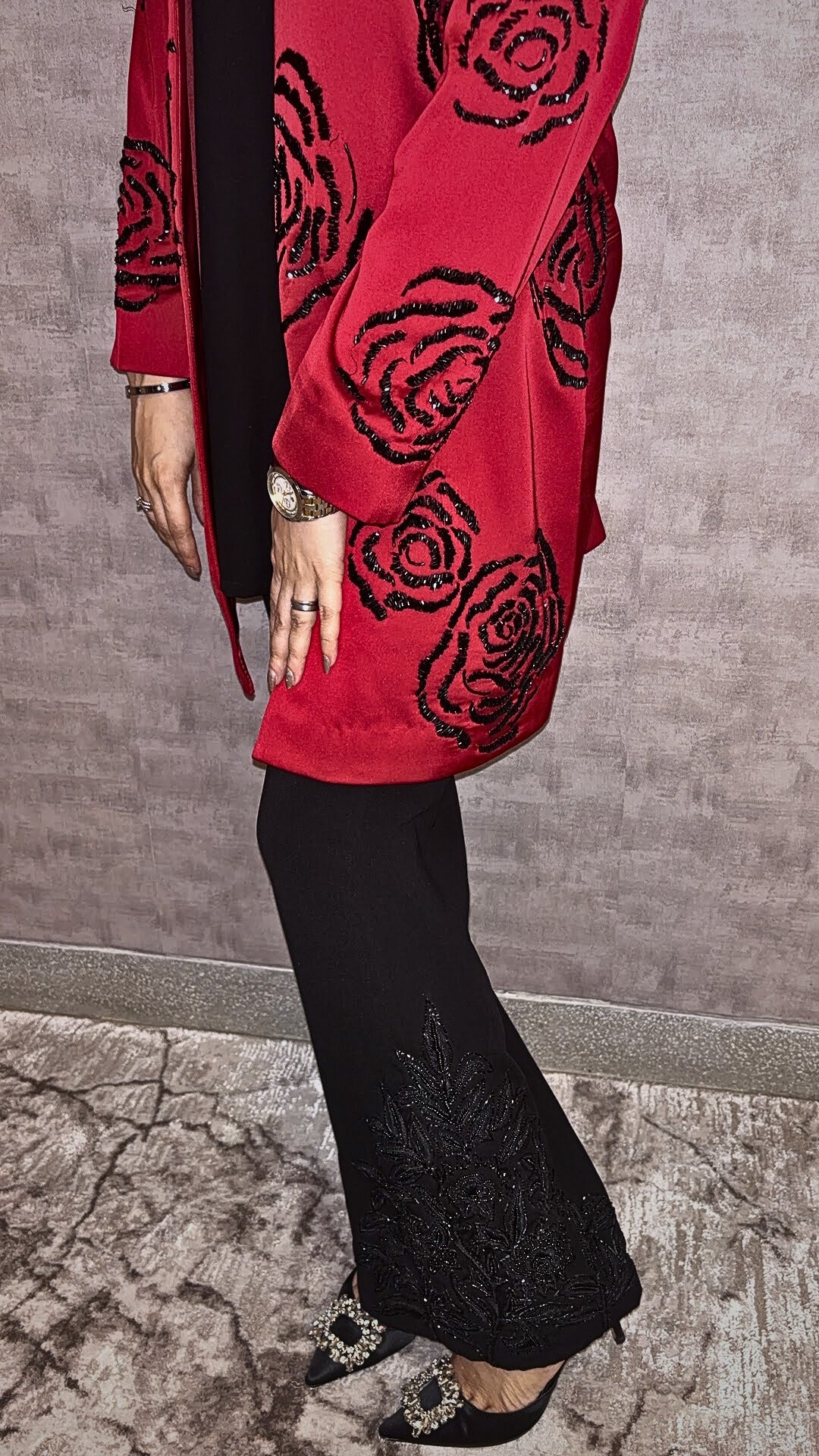 From Taraashi's exclusive Platinum Collection, the Satin Rose 3 Piece Set exudes undeniable glamour. A stunning red satin jacket showcases bold, dimensional black rose embellishments, a detail echoed subtly on the coordinating black trousers. Layered over a sleek inner top, this striking ensemble balances high-impact drama with sophisticated artistry. Command attention with the unforgettable style unique to our Platinum pieces.