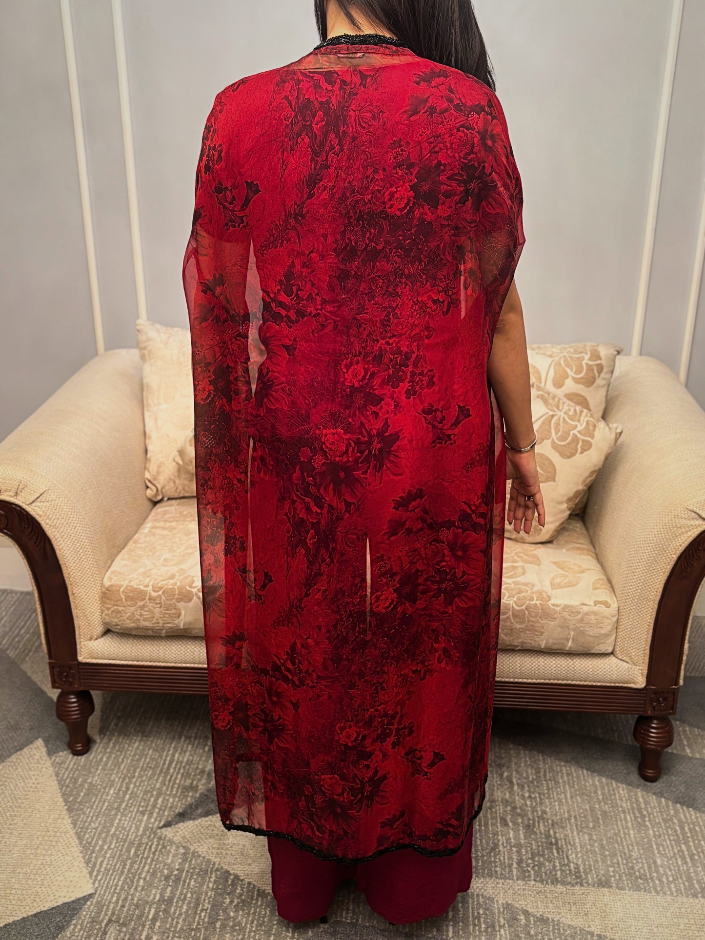 Bathed in the rich hue of a blossoming twilight, this Taraashi Platinum design drapes the wearer in an aura of captivating allure. The fluid silhouette, layered with a textured, almost ethereal fabric with intricate handwork (zardousi work), whispers of sophisticated grace. Delicate embellishments trace the edges, adding a touch of exquisite detail to the deep, resonant color. This is an attire for moments that demand attention, a seamless blend of tradition and contemporary finesse.