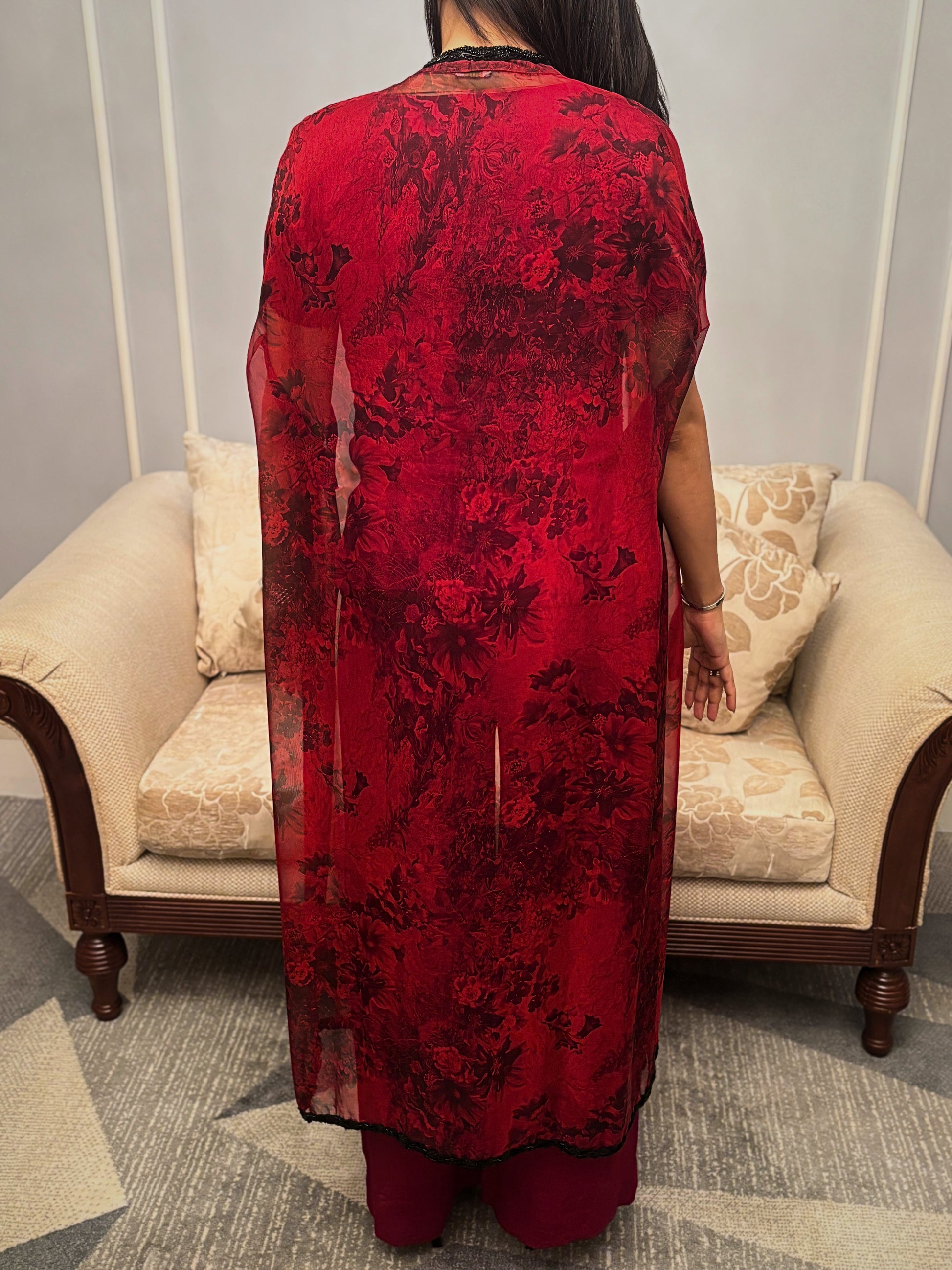 Bathed in the rich hue of a blossoming twilight, this Taraashi Platinum design drapes the wearer in an aura of captivating allure. The fluid silhouette, layered with a textured, almost ethereal fabric with intricate handwork (zardousi work), whispers of sophisticated grace. Delicate embellishments trace the edges, adding a touch of exquisite detail to the deep, resonant color. This is an attire for moments that demand attention, a seamless blend of tradition and contemporary finesse.