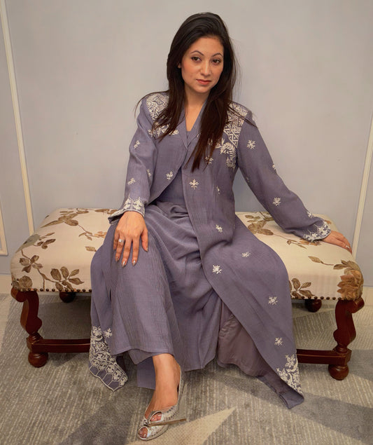 A quiet symphony of grace, the Twilight Vine three-piece set envelopes you in artisanal charm — where soft pleats meet ivory embroidery in timeless balance. The delicate handwork on the shoulders and cuffs evokes heirloom artistry, while the flowing silhouette speaks to the modern woman who prefers her elegance whispered, not declared.

Part of the Taraashi Platinum line — for evenings that deserve more than the ordinary.
