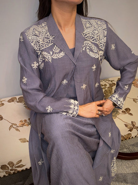 A quiet symphony of grace, the Twilight Vine three-piece set envelopes you in artisanal charm — where soft pleats meet ivory embroidery in timeless balance. The delicate handwork on the shoulders and cuffs evokes heirloom artistry, while the flowing silhouette speaks to the modern woman who prefers her elegance whispered, not declared.

Part of the Taraashi Platinum line — for evenings that deserve more than the ordinary.