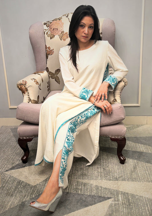 Grace finds its purest form in this ivory kurti set — where every drape whispers luxury and every thread is an ode to femininity. Crafted for evenings that linger and moments that matter, this ensemble pairs timeless charm with modern detail. From the fluid fall of the fabric to the delicate play of textures, this is not just attire — it’s presence, poised.