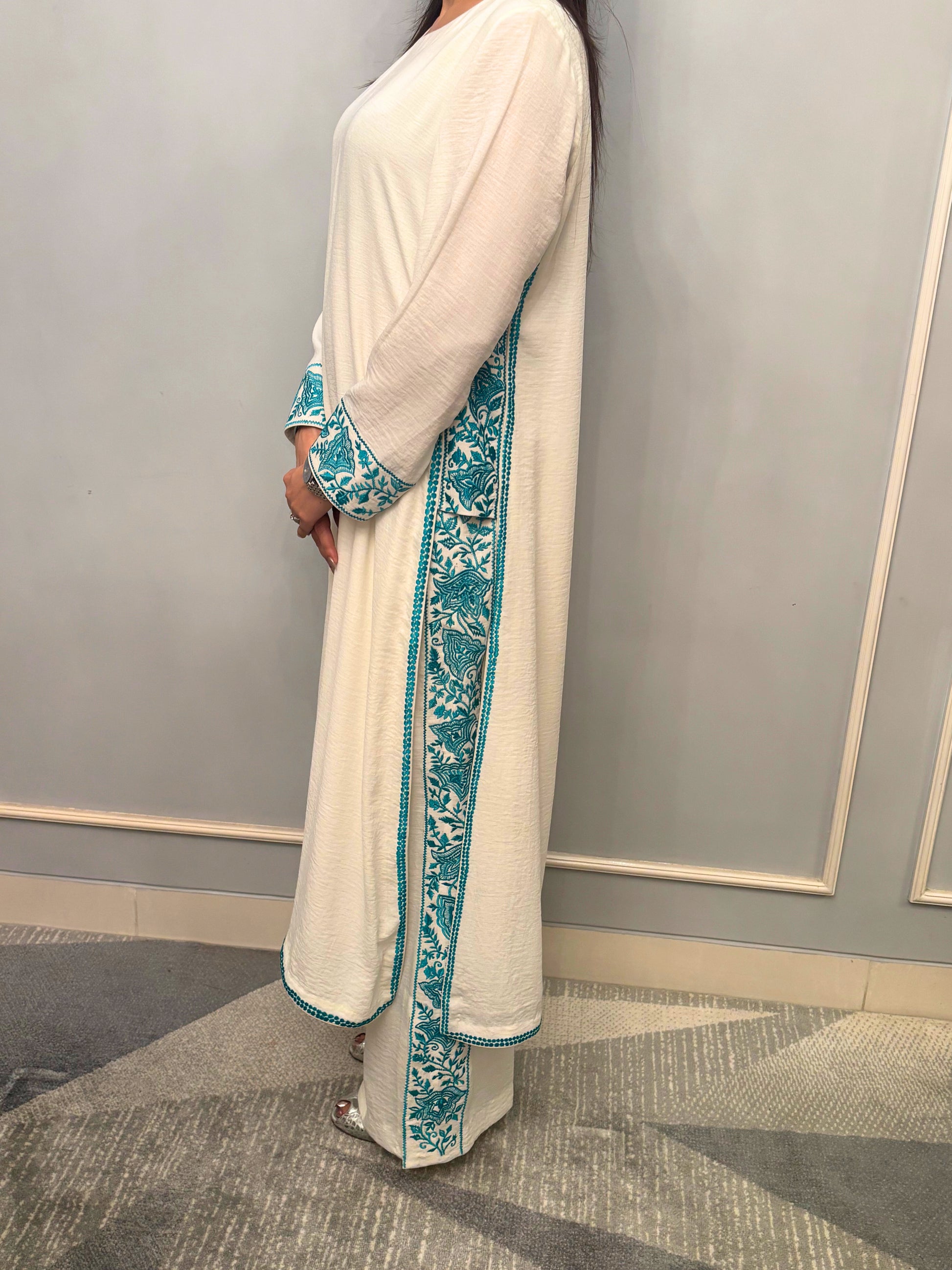 Grace finds its purest form in this ivory kurti set — where every drape whispers luxury and every thread is an ode to femininity. Crafted for evenings that linger and moments that matter, this ensemble pairs timeless charm with modern detail. From the fluid fall of the fabric to the delicate play of textures, this is not just attire — it’s presence, poised.